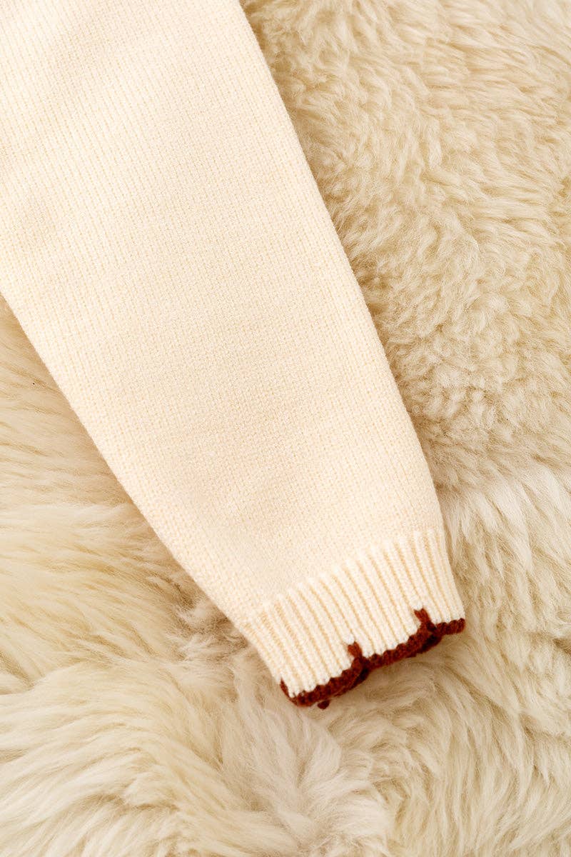 Horse shoe on cream knot pullover sweater w/moon stitch.