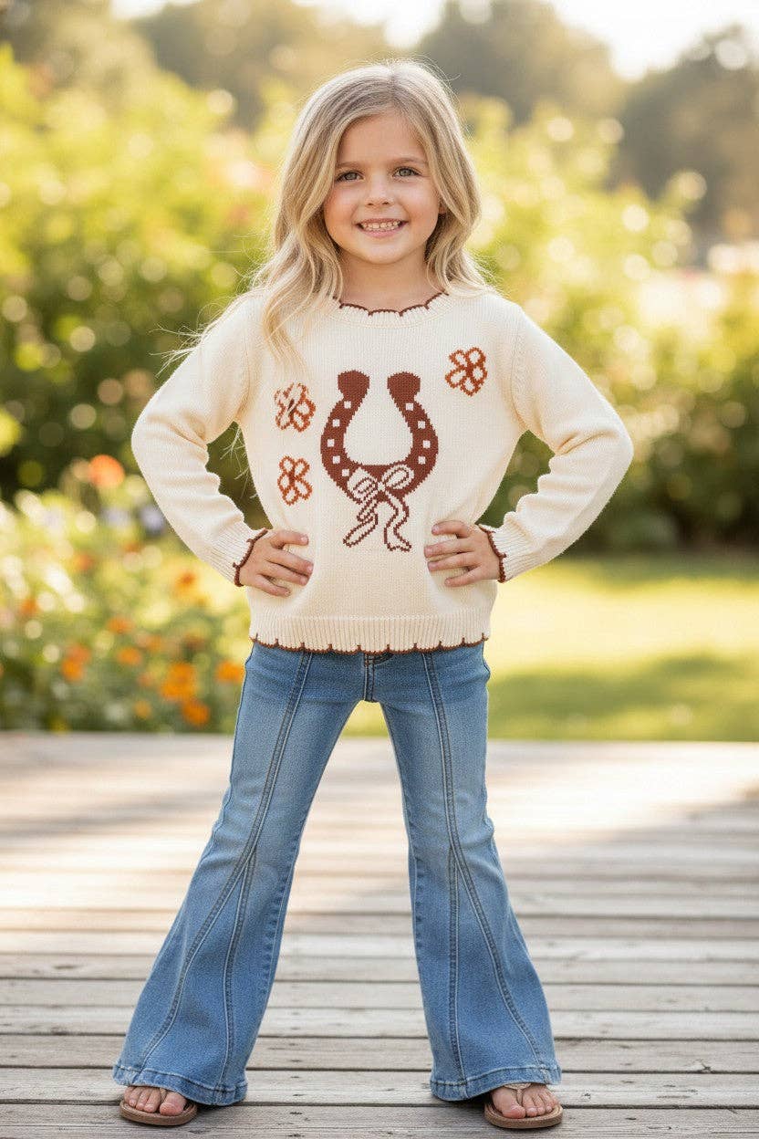 Horse shoe on cream knot pullover sweater w/moon stitch.