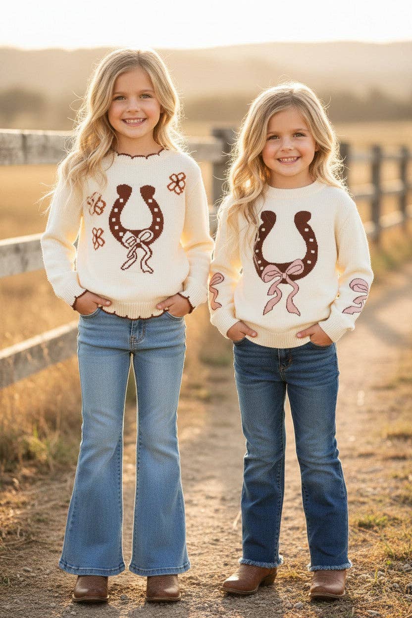 Horse shoe on cream knot pullover sweater w/moon stitch.